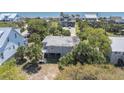 Beautiful aerial view of a coastal home, surrounded by lush palm trees and showcasing its proximity to the beach at 2604 Palmetto Blvd, Edisto Island, SC 29438