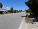 Street view of beautiful coastal neighborhood with tree-lined streets and charming beach homes at 2604 Palmetto Blvd, Edisto Island, SC 29438