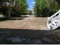Spacious outdoor yard surrounded by lush trees, perfect for creating an inviting gathering space at 2604 Palmetto Blvd, Edisto Island, SC 29438
