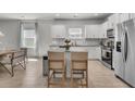 Bright kitchen with white cabinets, stainless steel appliances, and a granite-topped island with seating at 2809 Conservancy Ln, Charleston, SC 29414