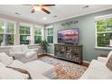 Bright living room with large windows, a modern TV, and comfortable seating at 314 Beverly Dr, Ladson, SC 29456