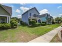 Charming two-story home with a well-manicured lawn and inviting front porch in a suburban neighborhood at 317 Pimpernel St, Summerville, SC 29483