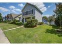 Charming two-story home with a well-manicured lawn and inviting front porch in a suburban neighborhood at 317 Pimpernel St, Summerville, SC 29483