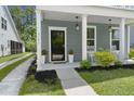 Cozy front porch features rocking chairs and beautiful landscaping at 3191 Moonlight Dr, Charleston, SC 29414