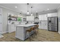 Spacious kitchen with white cabinetry, stainless steel appliances, center island, and modern pendant lighting at 3361 Olivia Marie Ln, Johns Island, SC 29455