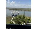 Waterfront view with dock, with seating and cooking space at 3807 Scott Creek Dr, Edisto Island, SC 29438