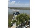 Waterfront view with dock, with seating and cooking space at 3807 Scott Creek Dr, Edisto Island, SC 29438