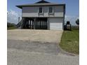 Elevated home with garage parking and a large concrete driveway at 3807 Scott Creek Dr, Edisto Island, SC 29438