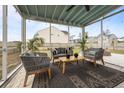 Comfortable screened porch with stylish outdoor furniture and a view of the backyard at 401 Carrara Dr, Summerville, SC 29486