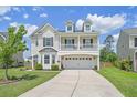 Charming two-story home featuring a two-car garage, a cozy second-story balcony, and a well-kept lawn at 4024 Exploration Rd, Ladson, SC 29456