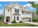 Inviting two-story home with a two-car garage, charming second-story balcony, and well-maintained front lawn at 4024 Exploration Rd, Ladson, SC 29456