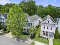 Birds eye view showcases the charming homes surrounded by lush trees with a manicured lawn creating a vibrant and desirable neighborhood at 404 Forsythia Ave, Summerville, SC 29483