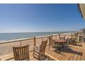 Oceanfront deck with outdoor seating for enjoying panoramic views of the beach and the sea at 412 Palmetto Blvd, Edisto Island, SC 29438