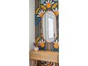Stylish entryway showcasing a mirror, console table and vibrant patterned wallpaper at 4503 Overbrook Ave, North Charleston, SC 29405