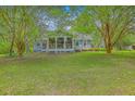 Lovely home exterior with a screened-in porch perfect for enjoying the outdoors at 4942 Storage Rd, Meggett, SC 29449