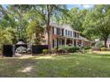 Brick two-story home with black trim and a private side yard featuring a boat at 501 Willow Branch Way, Mount Pleasant, SC 29464