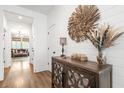 Elegant entryway featuring hardwood floors, a decorative mirror, and a stylish wooden cabinet at 518 Sound Dr, Summerville, SC 29486
