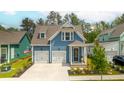Charming blue two-story home with white trim, two-car garage, and landscaped front yard at 518 Sound Dr, Summerville, SC 29486