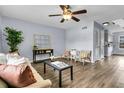 Inviting living room with stylish decor, wood floors, and a ceiling fan at 5737 Dewsbury Ln, North Charleston, SC 29418