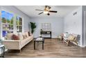 Bright living room featuring wood floors, lots of natural light, and a decorative ceiling fan at 5737 Dewsbury Ln, North Charleston, SC 29418