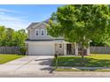 Traditional home featuring manicured lawn, covered front porch, and neutral color scheme at 606 Knowledge Dr, Ladson, SC 29456