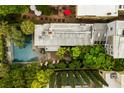 An aerial view of this home highlights the mature landscaping and the backyard pool at 62 Society St, Charleston, SC 29401