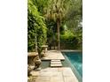 This home's in-ground pool offers a step stone entrance, luscious landscaping, and a private retreat at 62 Society St, Charleston, SC 29401