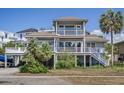 Charming two-story home showcasing multiple balconies and covered parking for vehicles and boats at 625 Ocean Blvd, Isle of Palms, SC 29451