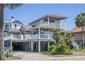 Charming home with a covered boat/car port, multiple balconies, and lush tropical landscaping at 625 Ocean Blvd, Isle of Palms, SC 29451