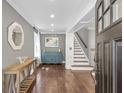 A welcoming foyer features hardwood floors, elegant trim, and a staircase at 699 Castle Pinckney Dr, James Island, SC 29412