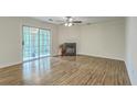 Spacious living room boasts a fireplace, access to a sunroom, and beautiful hardwood flooring at 7965 Edgebrook Cir # F, North Charleston, SC 29418