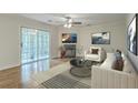 Bright living room features a cozy fireplace, stylish decor, and sliding glass doors to a patio at 7965 Edgebrook Cir # F, North Charleston, SC 29418