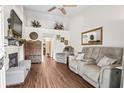 Cozy living room with hardwood floors, stone fireplace, and plush seating at 801 Reserve Way, Summerville, SC 29485