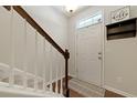 Welcoming foyer with stairs, hardwood floors, and coat rack by the front door at 849 Bibury Ct, Charleston, SC 29414