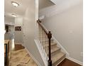 Carpeted staircase leading to the upper level of the home with hardwood floors at 849 Bibury Ct, Charleston, SC 29414