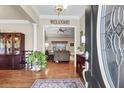 Welcoming foyer showcasing hardwood floors, a decorative rug, and an open view to the living room at 1069 Blockade Runner Pkwy, Summerville, SC 29485