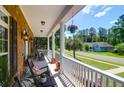 Relaxing front porch with rocking chairs, plants, and a view of the street at 1069 Blockade Runner Pkwy, Summerville, SC 29485
