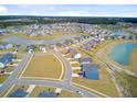 Aerial view of a neighborhood featuring many homes and community lakes at 107 Pescaro Ln, Summerville, SC 29486
