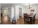 Bright dining room with hardwood floors, white trim, and a view into the kitchen at 1087 Clearspring Dr, Charleston, SC 29412