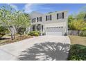 Charming two-story home with white trim, a covered porch, and a two-car garage at 1087 Clearspring Dr, Charleston, SC 29412