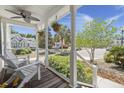 Inviting front porch with ceiling fan, white rocking chairs, and well-maintained landscaping at 1087 Clearspring Dr, Charleston, SC 29412