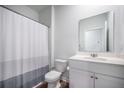 Bathroom featuring a shower-tub combo with shower curtain and a white single sink vanity at 110 Green Passage Ln, Summerville, SC 29486