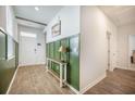 Inviting foyer with a decorative table lamp and eye-catching green wall paneling at 110 Green Passage Ln, Summerville, SC 29486