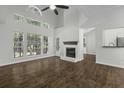 Bright living room with large windows, fireplace, and hardwood floors, creating a cozy space at 110 Mapperton Ct, Summerville, SC 29485