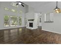 Bright living room with large windows, fireplace, and hardwood floors, creating a cozy space at 110 Mapperton Ct, Summerville, SC 29485