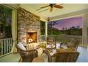 Relaxing outdoor porch with a stone fireplace and comfortable seating, perfect for enjoying evenings at 112 Berkshire Dr, Wando, SC 29492