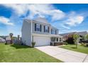 Beautiful two-story home featuring a well-maintained lawn, an attached two-car garage and a welcoming front porch at 1130 Moss Grove Dr, Moncks Corner, SC 29461