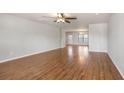Spacious living room with hardwood floors, neutral paint, ceiling fan, and ample natural light creating a warm and inviting atmosphere at 1130 Moss Grove Dr, Moncks Corner, SC 29461