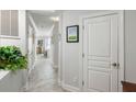 Hallway entrance boasts neutral walls and an art accent, leading to a sunlit space with a kitchen island at 1140 Ocean Blvd # 201, Isle of Palms, SC 29451