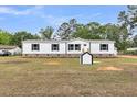 Home with a well-manicured lawn and charming outdoor shed at 119 Silver King Ave, Cross, SC 29436